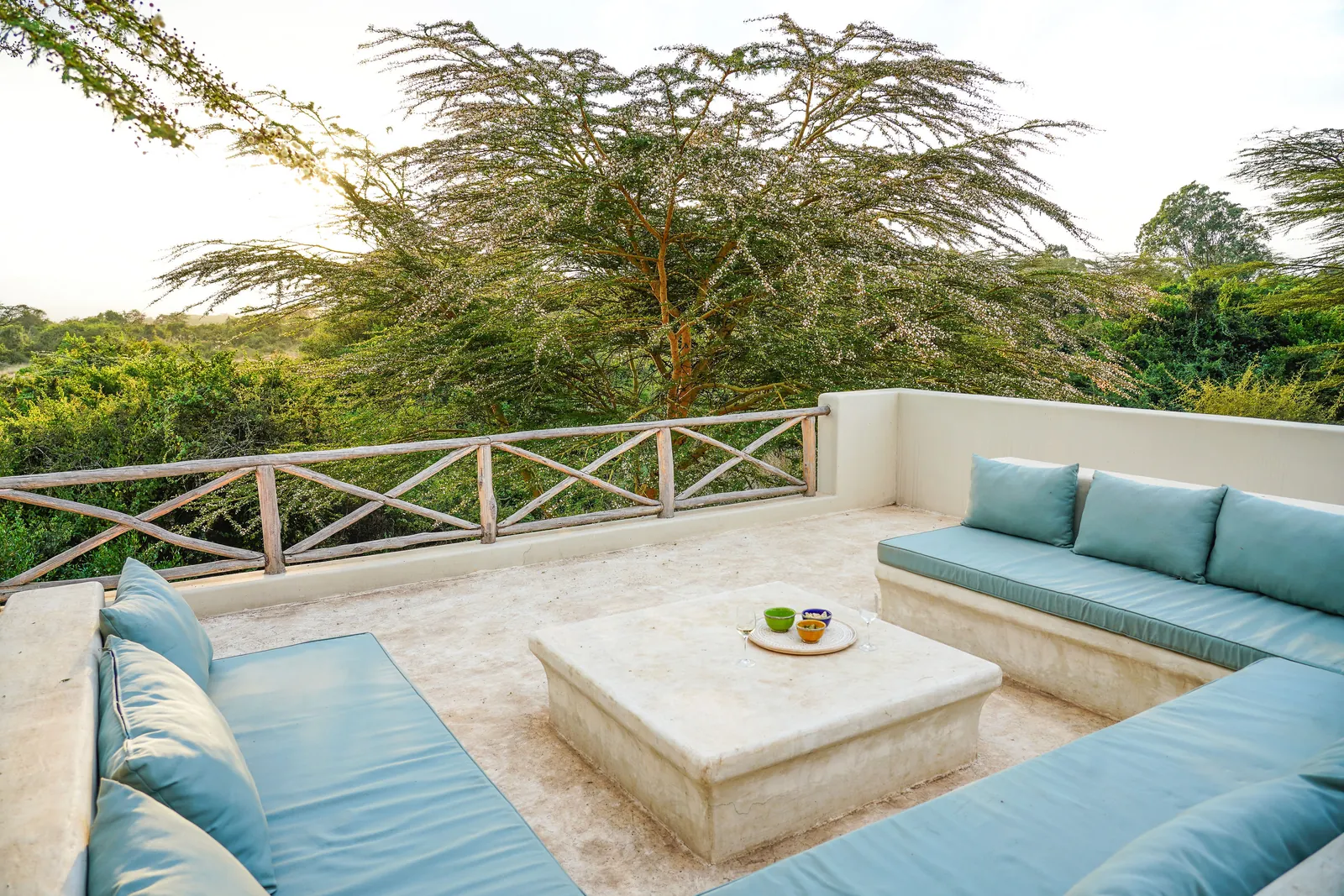 The rooftop terrace at Nairobi Pool Nest, with built-in seating under the acacias