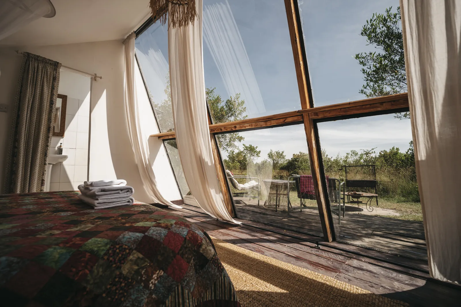 The bed at A-Frame Nest, facing the glass wall