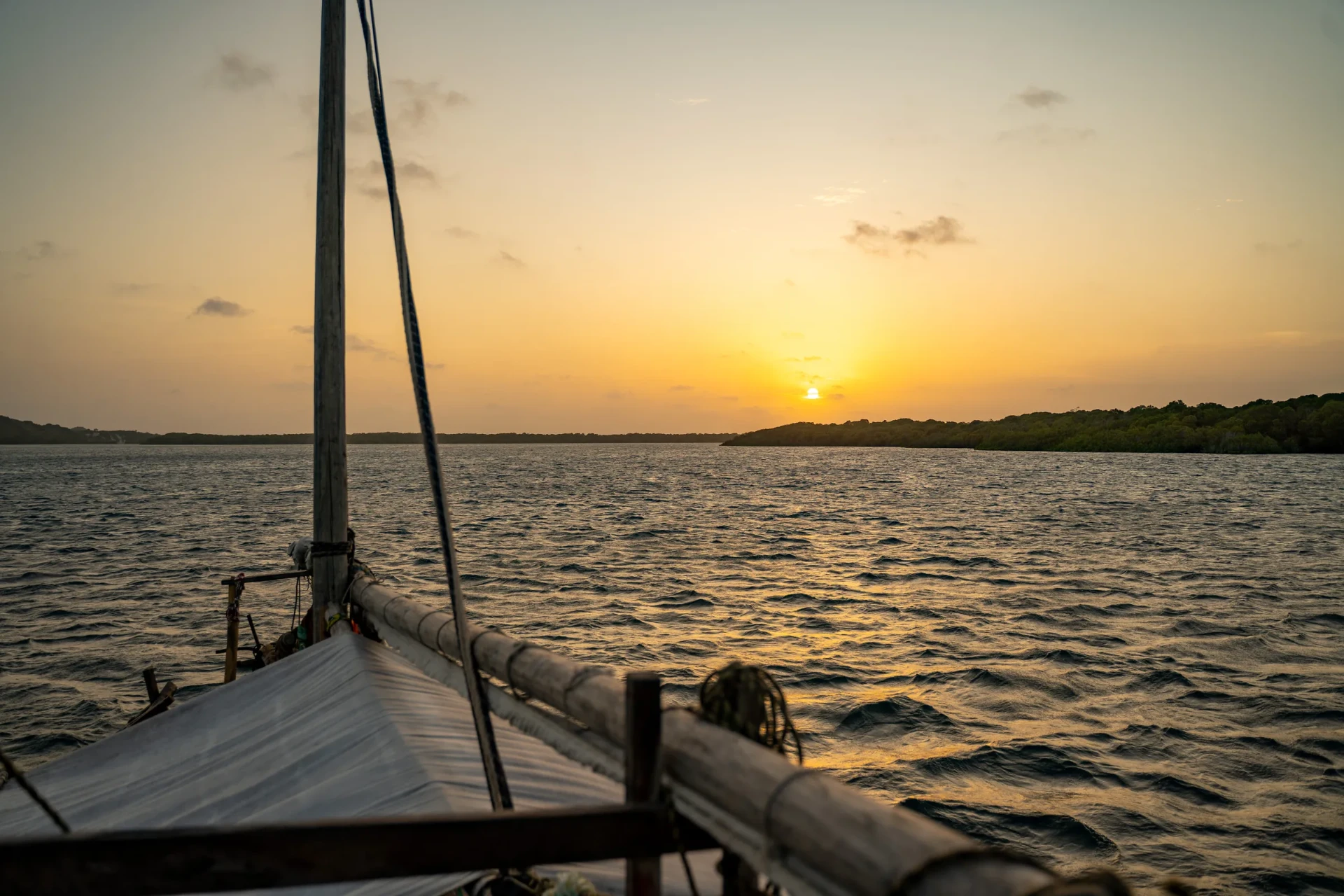 Sunset seen from the deck of the Elsabella, the bowsprit silhouetted against the water