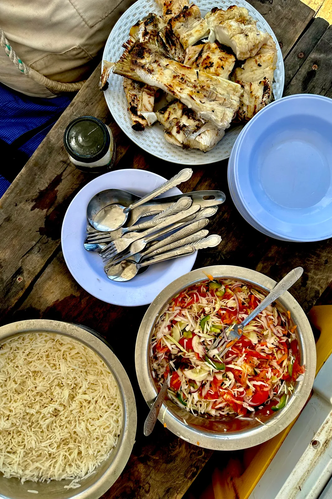 Lunch laid out on deck, rice and a tomato dish served in bowls