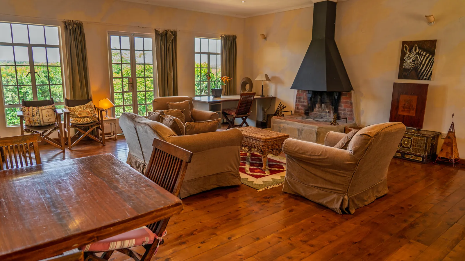 The sitting room at Asili Cottage, with armchairs around the fireplace