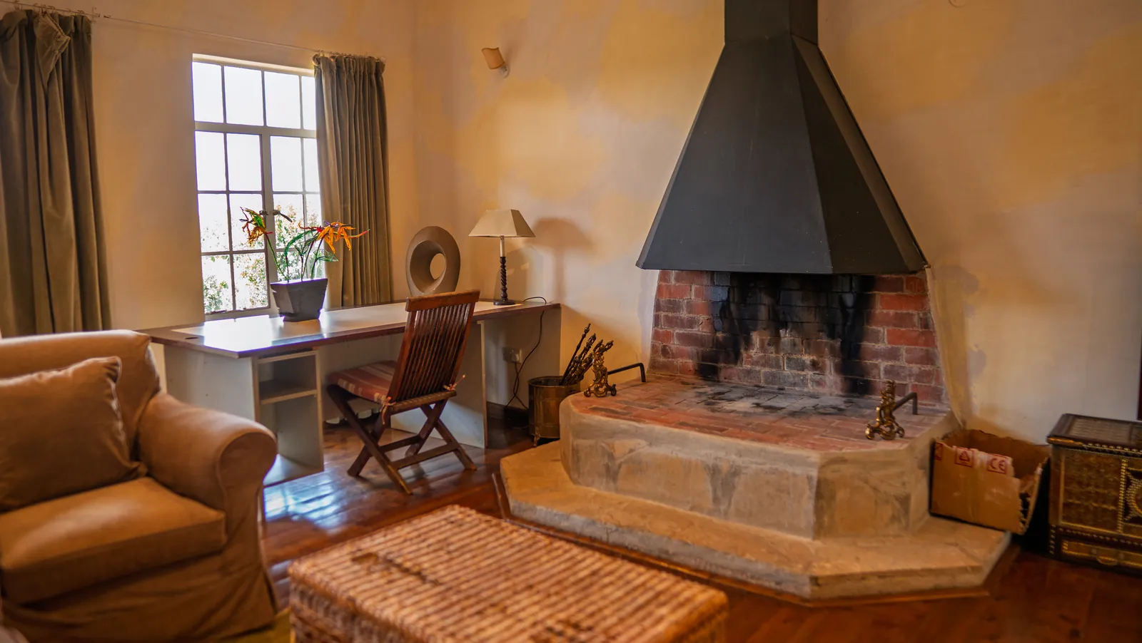 A sitting area by the fire at Asili Cottage