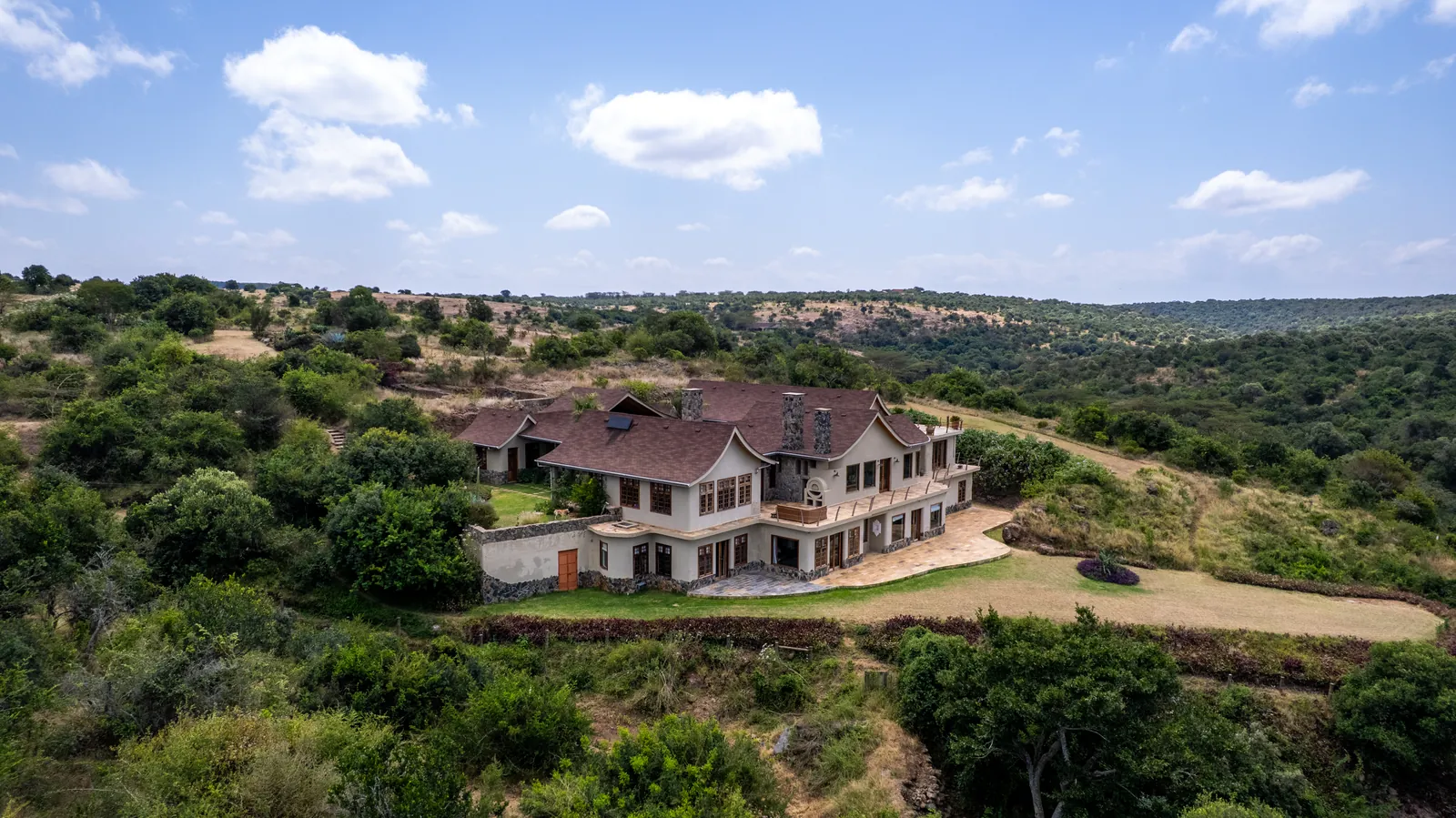 Asili House on its hillside above the valley, from the air
