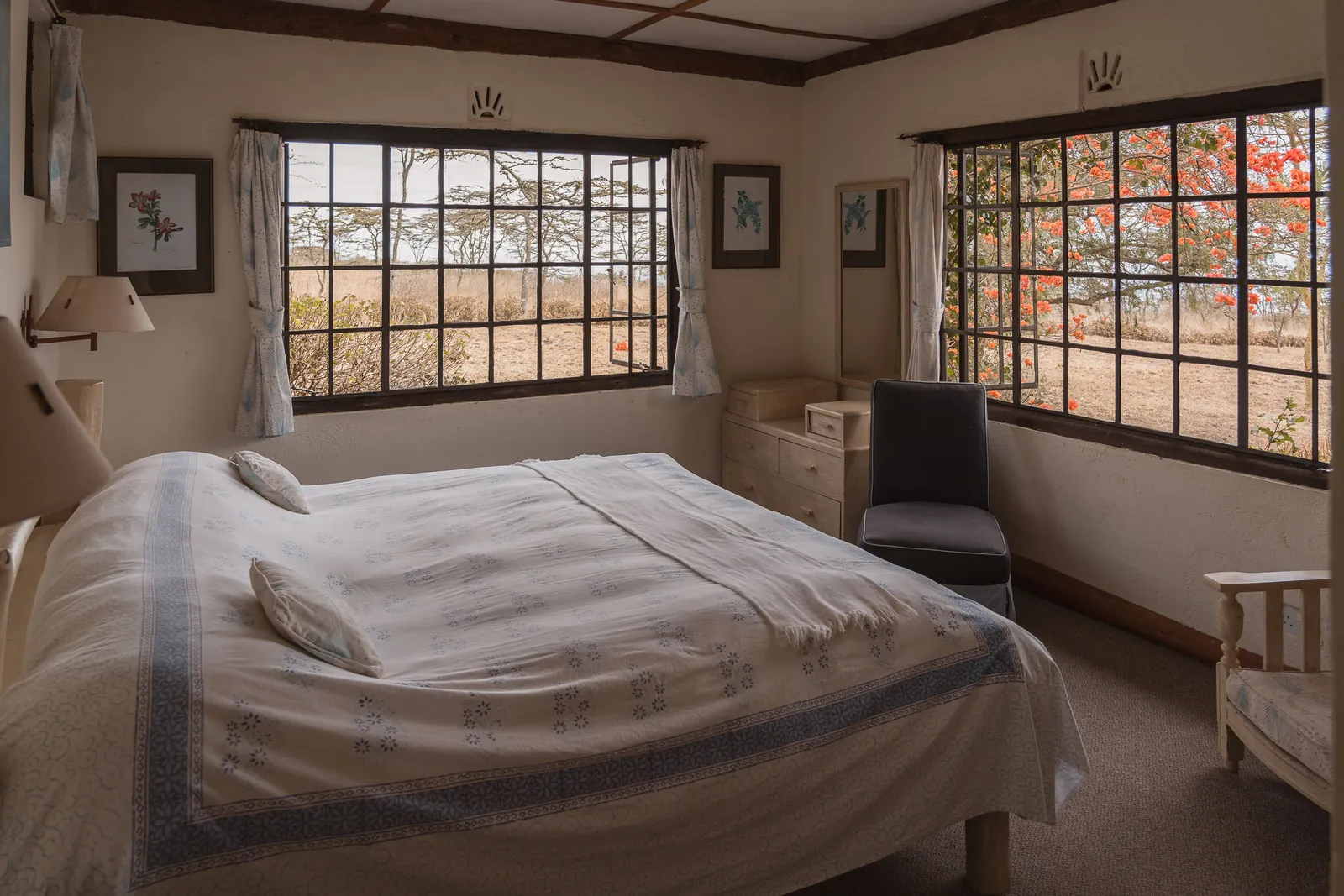 A second double bedroom at Champagne Ridge Nest, with two large windows and orange blossom outside